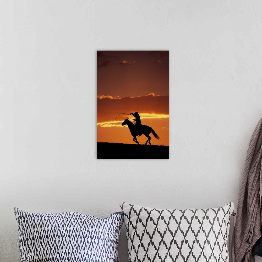 A bohemian room featuring Silhouette of cowboy on horseback at sunset