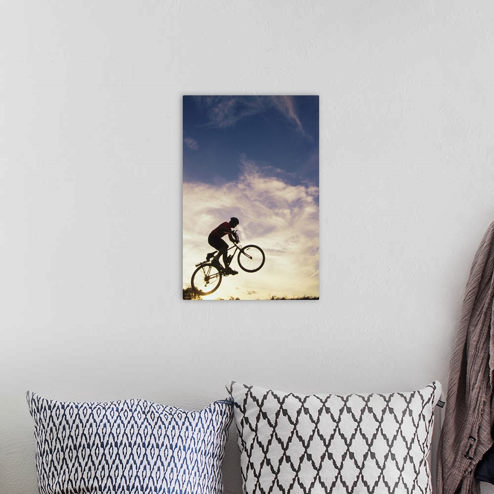 A bohemian room featuring Silhouette of man in mid-air on mountain bike