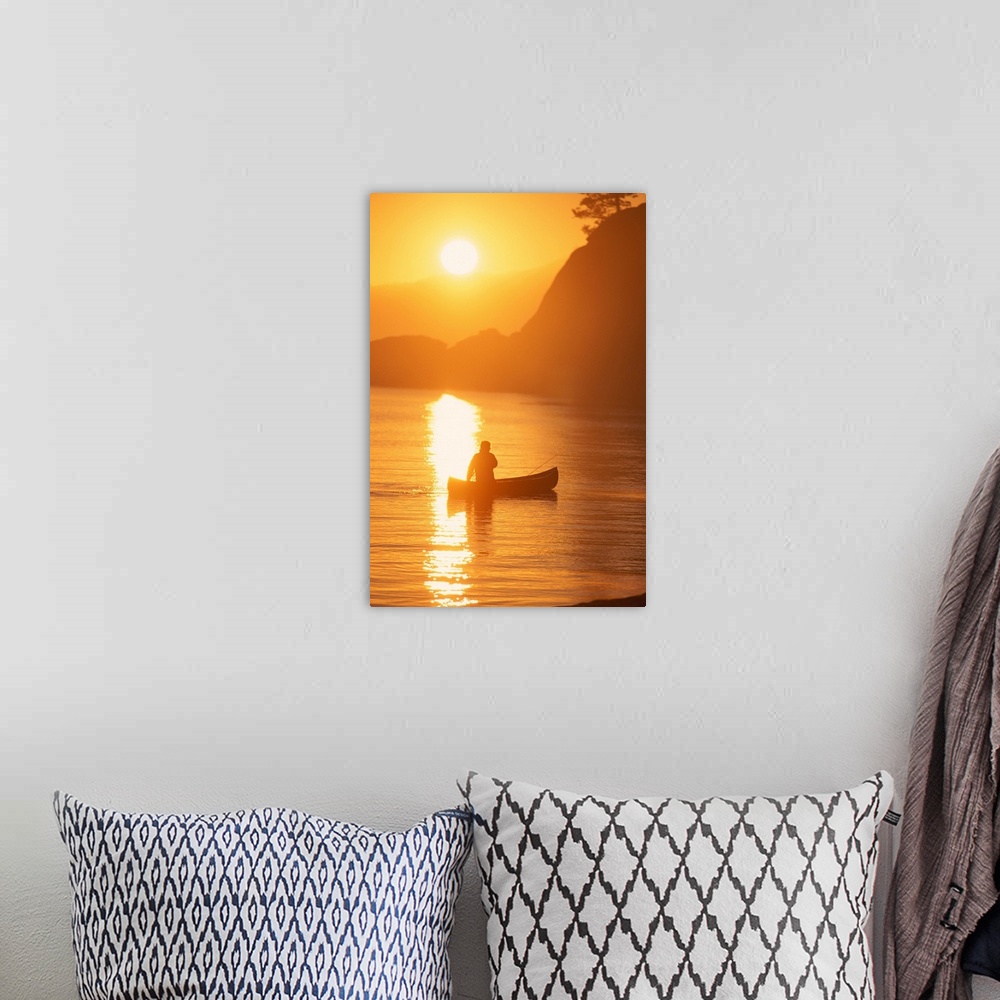 A bohemian room featuring Silhouette of person canoeing at sunset