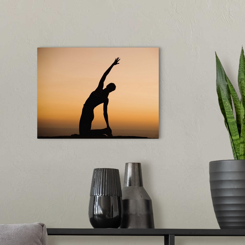 A modern room featuring Silhouette of person stretching