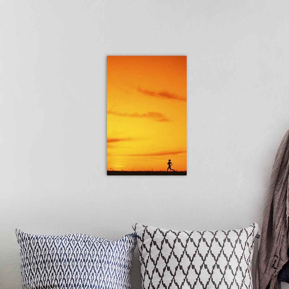 A bohemian room featuring Silhouette of runner at sunset