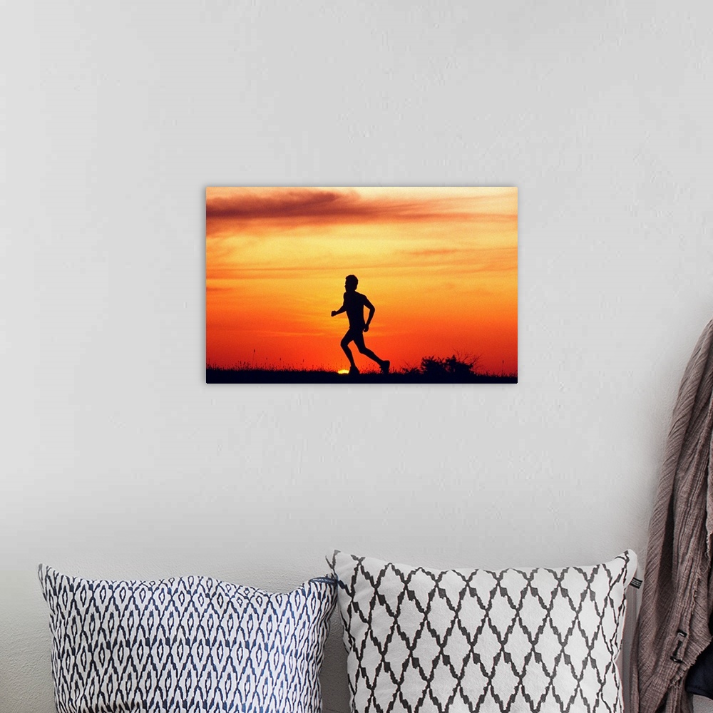 A bohemian room featuring Silhouette of runner on ridge at sunset