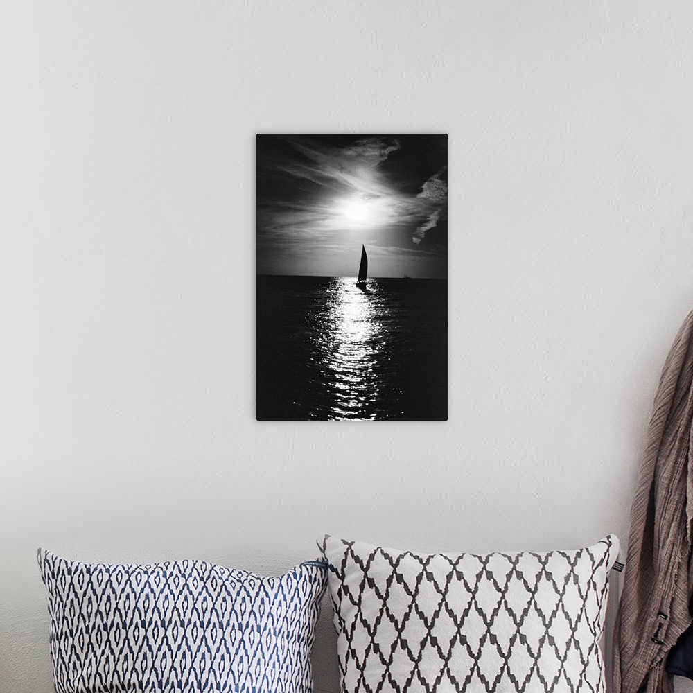 A bohemian room featuring Silhouette of sailboat at sea