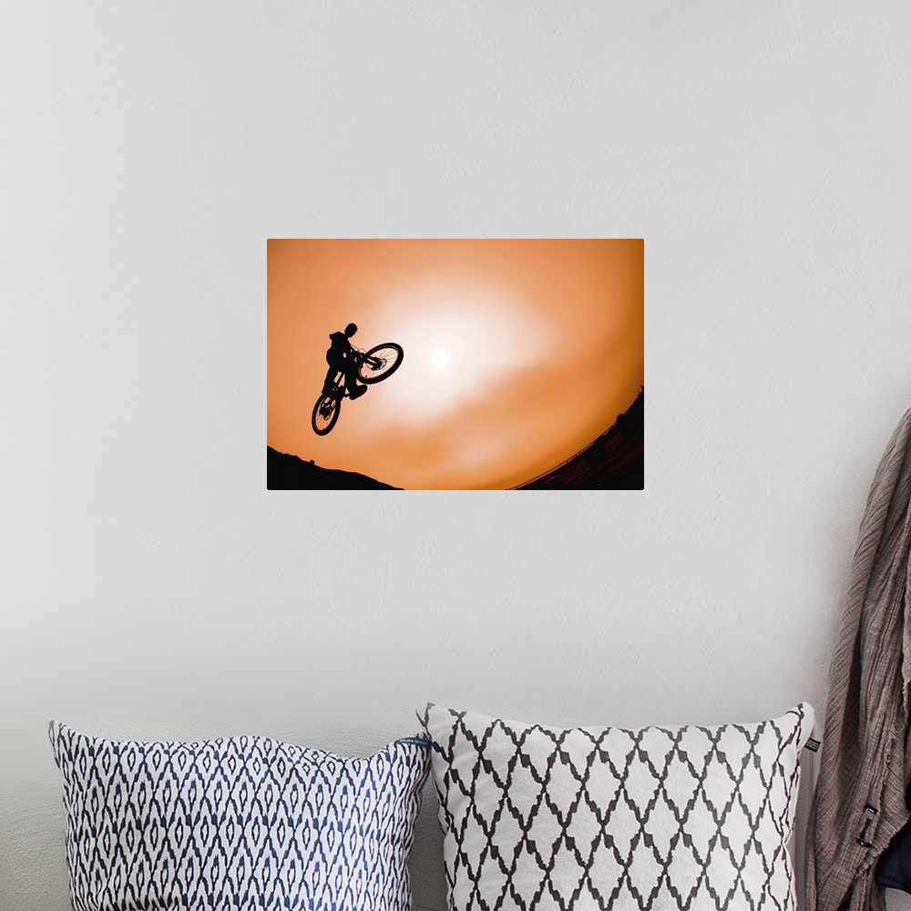 A bohemian room featuring Silhouette of stunt cyclist