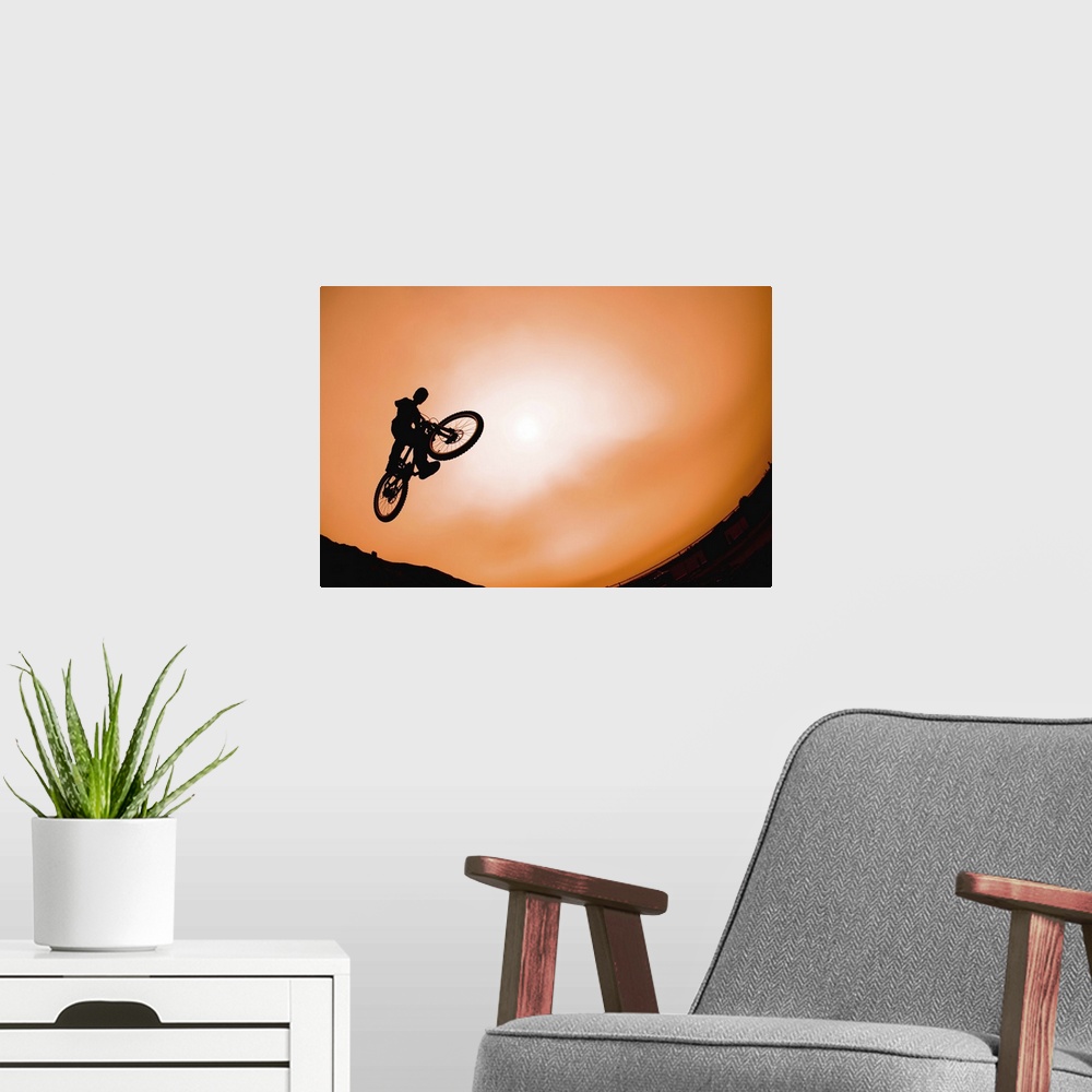 A modern room featuring Silhouette of stunt cyclist