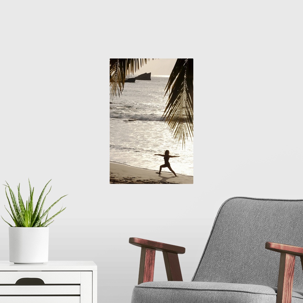 A modern room featuring Silhouette of woman doing yoga on beach