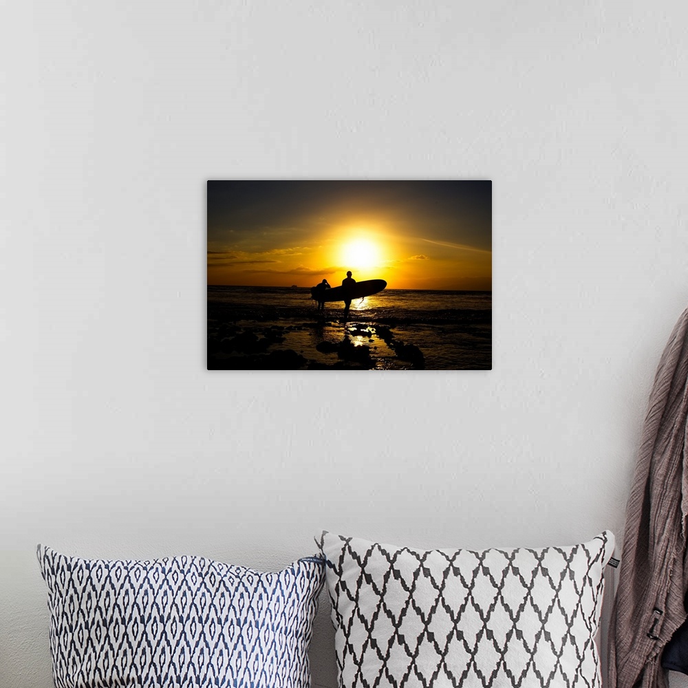 A bohemian room featuring Silhouette surfers on beach at sunset.