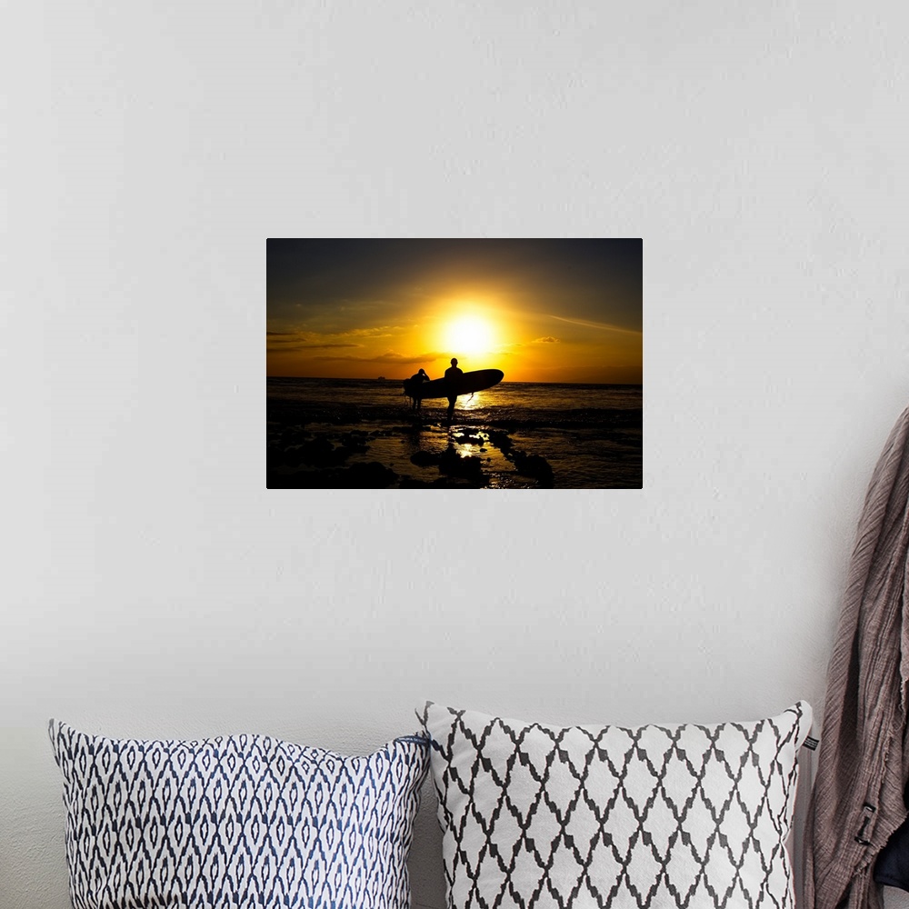A bohemian room featuring Silhouette surfers on beach at sunset.