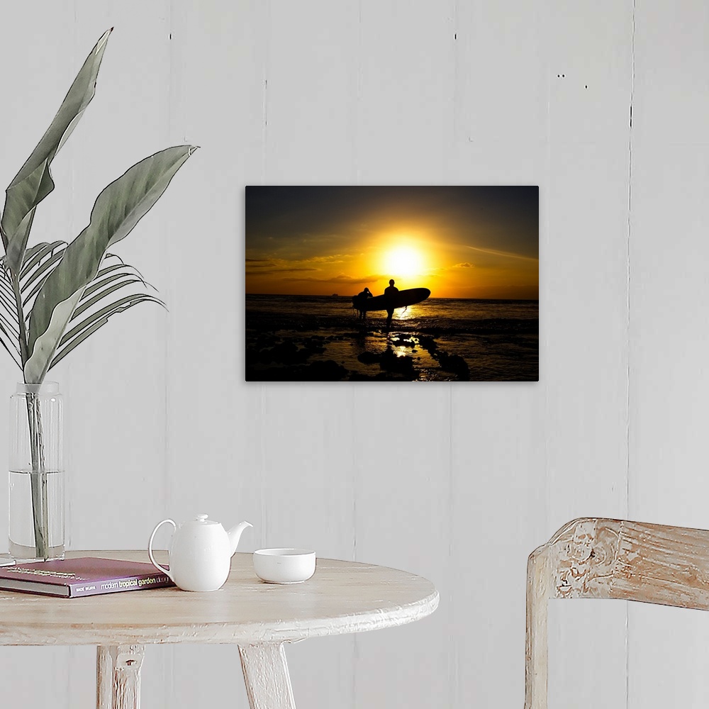 A farmhouse room featuring Silhouette surfers on beach at sunset.