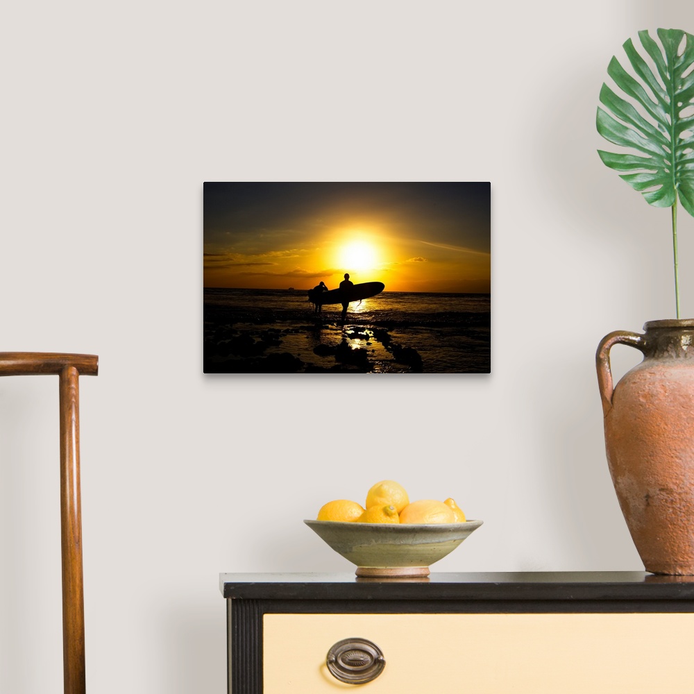 A traditional room featuring Silhouette surfers on beach at sunset.