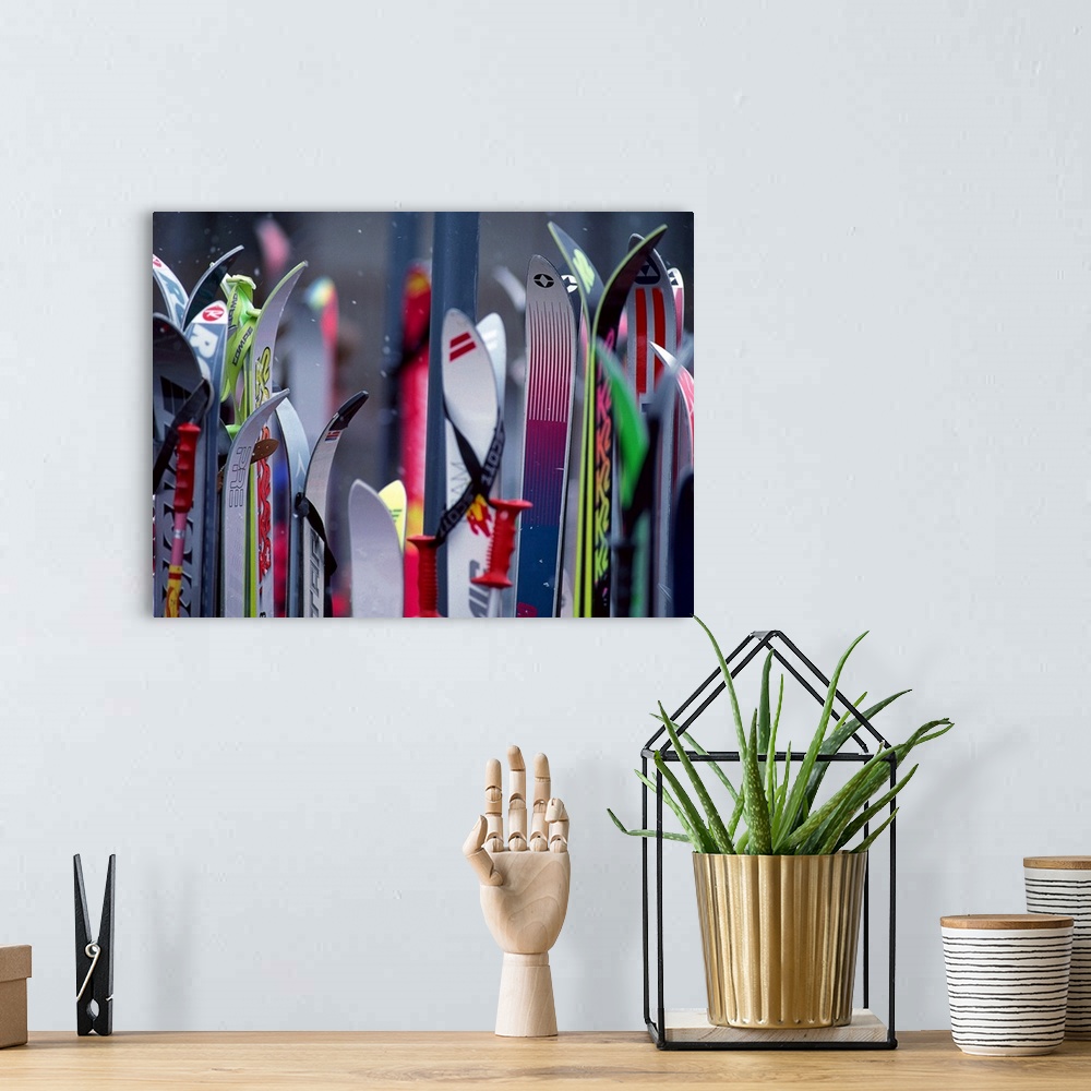 A bohemian room featuring Big, landscape photograph of the tops of many colorful ski boards on a slightly out of focus back...