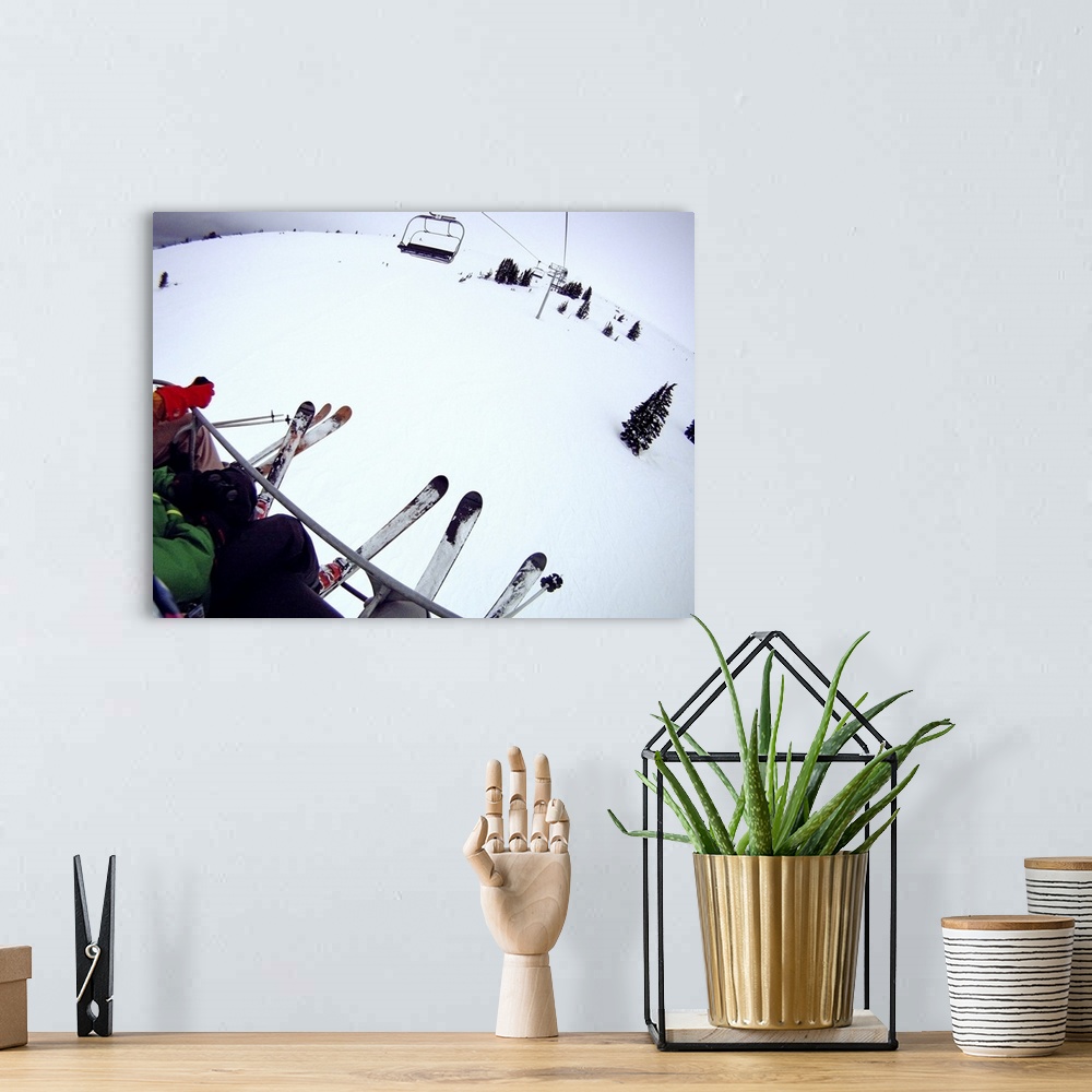 A bohemian room featuring Skiers sitting on chairlift.