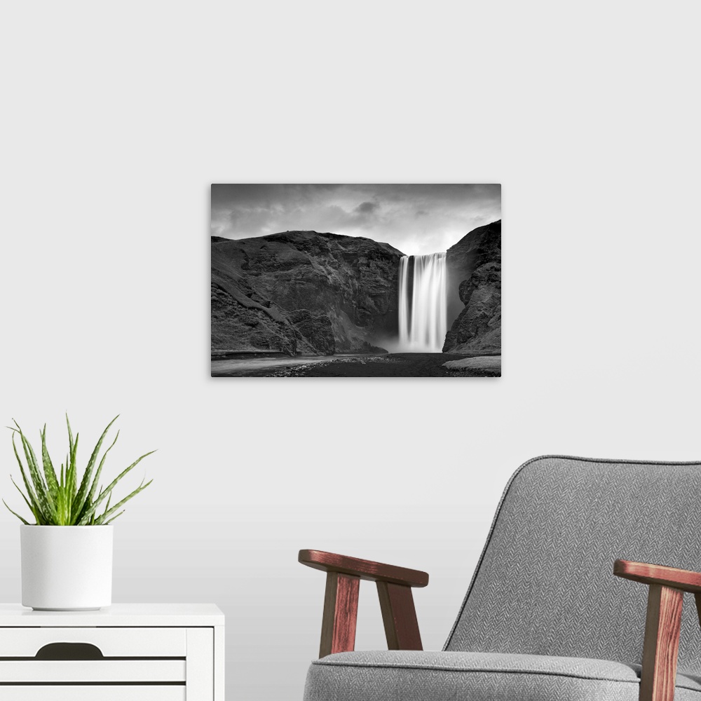 A modern room featuring Skogafoss waterfall plunges over old sea cliffs on south coast of Iceland.