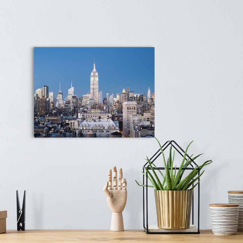 A bohemian room featuring Skyline of Midtown Manhattan with Empire State Building at dusk
