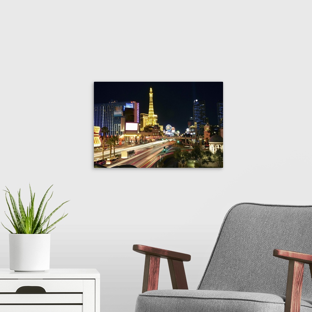 A modern room featuring Skyline of 'Paris Las Vegas' and the 'Eiffel tower' on Las Vegas Boulevard illuminated at night