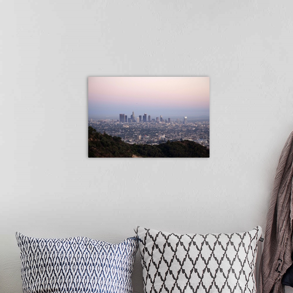 A bohemian room featuring Landscape view of skyscrapers of downtown LA with hills of Griffith Park in foreground as seen at...