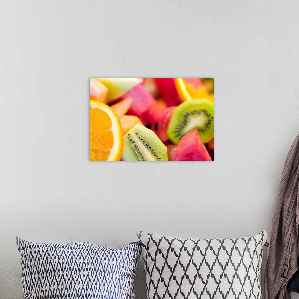 A bohemian room featuring Photograph of cut oranges, kiwi, watermelon, and cantaloupe.