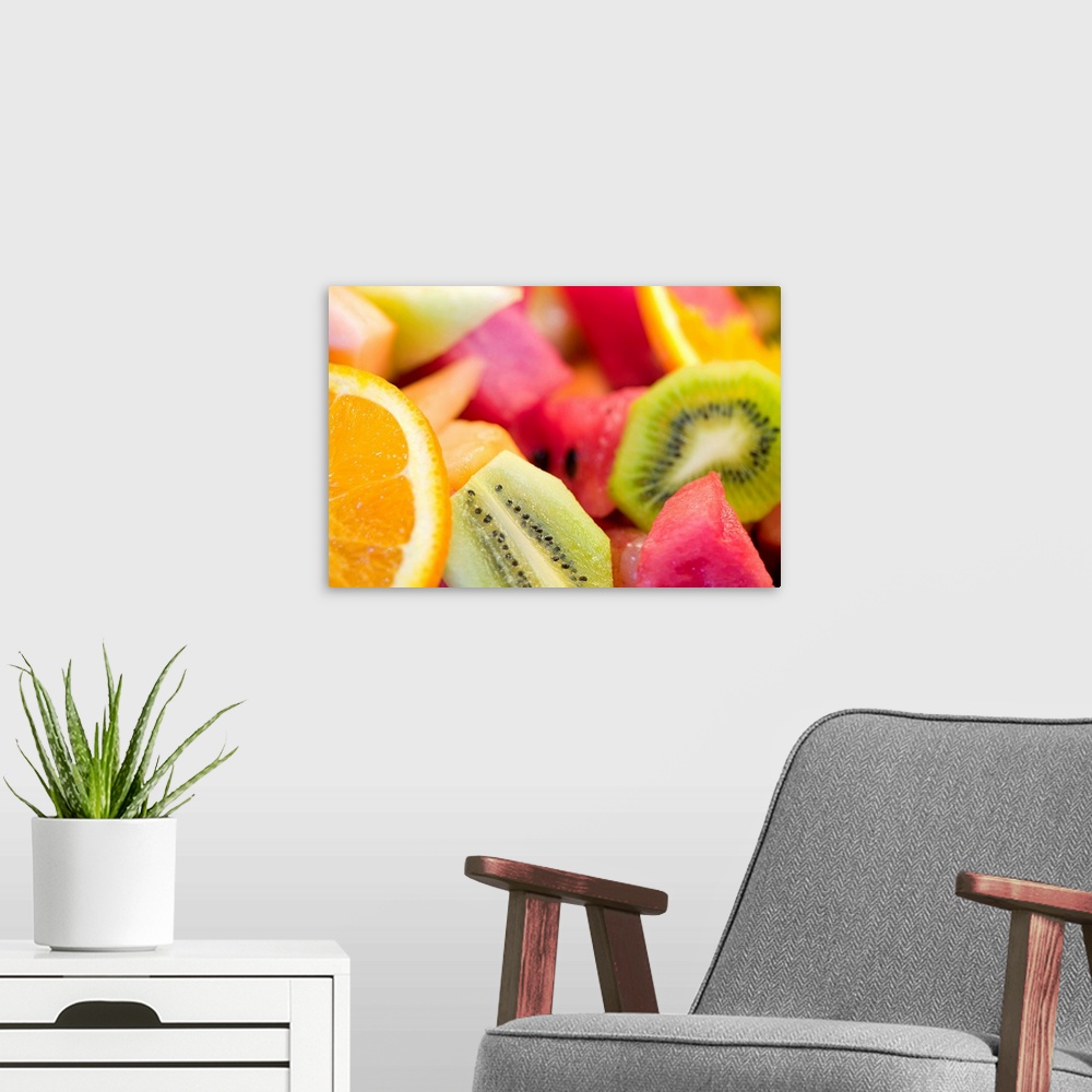 A modern room featuring Photograph of cut oranges, kiwi, watermelon, and cantaloupe.