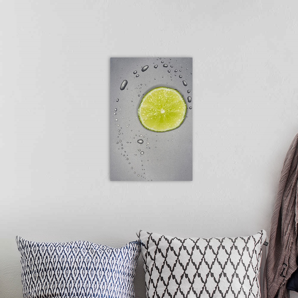 A bohemian room featuring This photograph is taken of a slice of a lime with water droplets surrounding it on a grey surface.