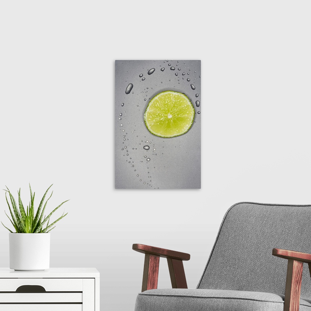 A modern room featuring This photograph is taken of a slice of a lime with water droplets surrounding it on a grey surface.