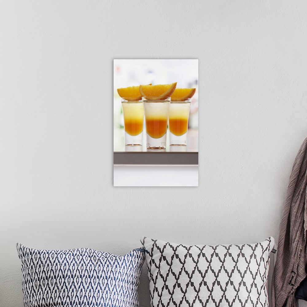 A bohemian room featuring Slices of orange on drinks in shot glasses