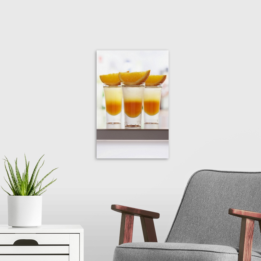 A modern room featuring Slices of orange on drinks in shot glasses