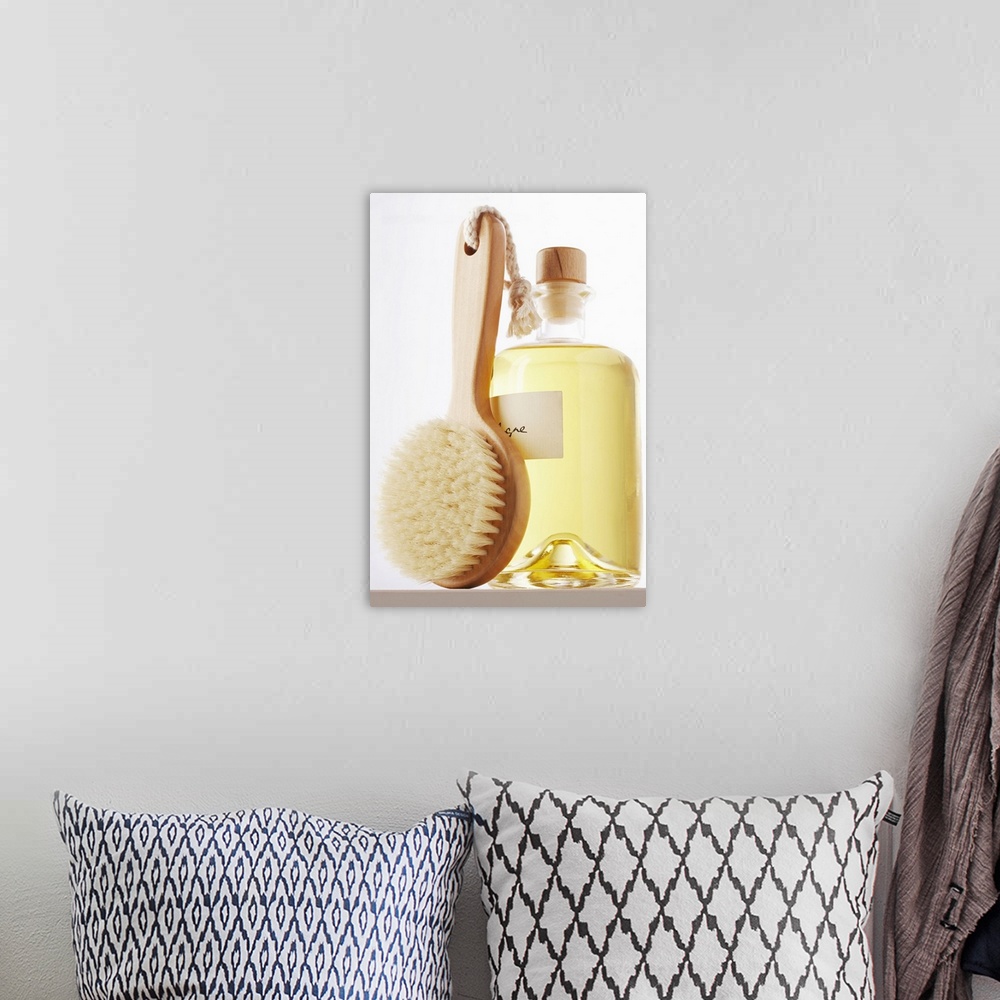 A bohemian room featuring Small bath brush leaning against jar of eau de cologne, close-up