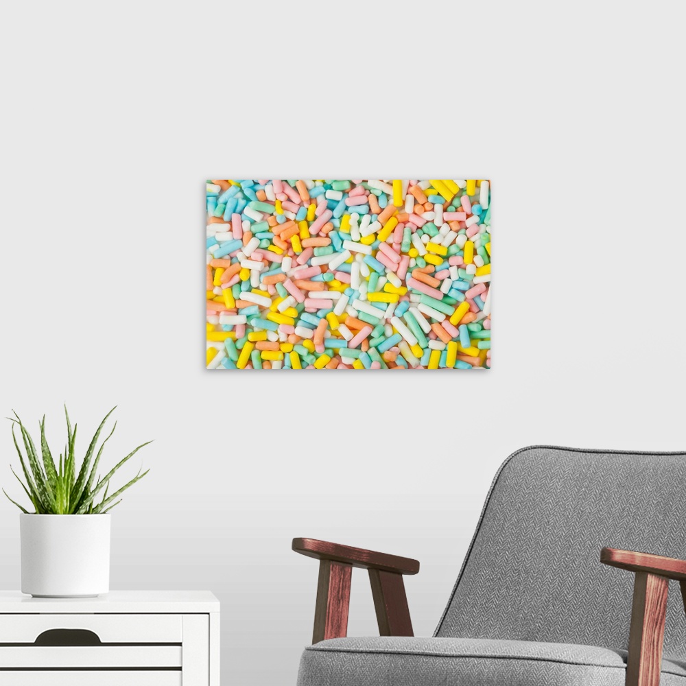 A modern room featuring Macro image of a small scoop of pastel-colored dessert sprinkles. Shot in-studio with Canon 5D2 a...