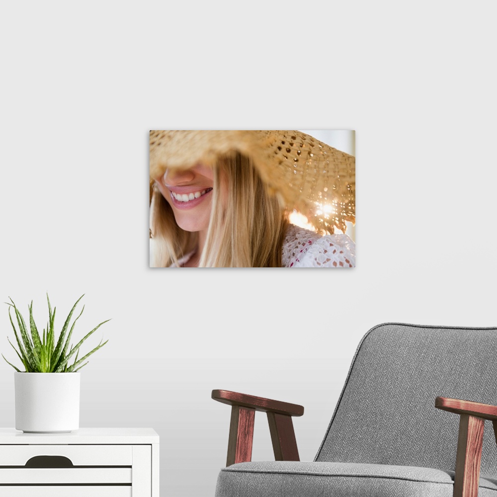 A modern room featuring Smiling young woman wearing straw hat