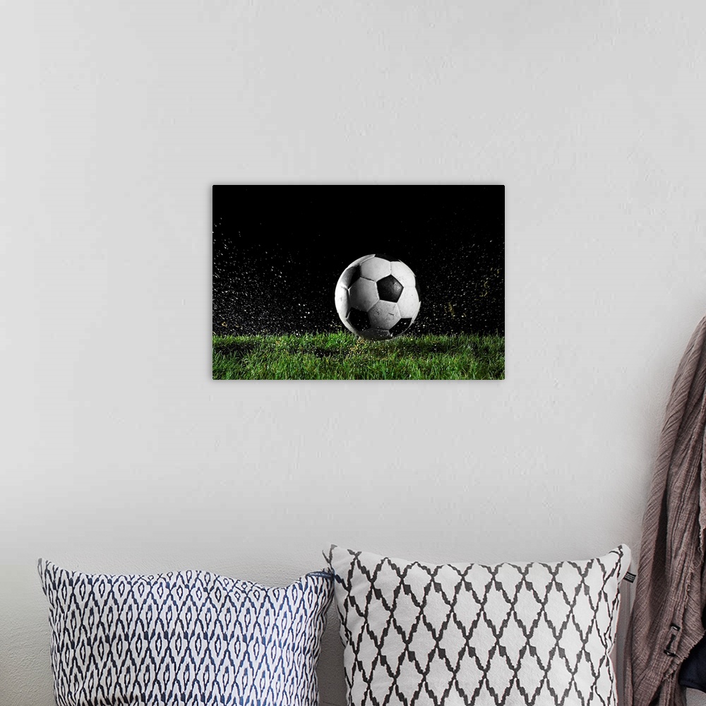 A bohemian room featuring Photographic print of a soccer ball moving across wet grass from a kick.
