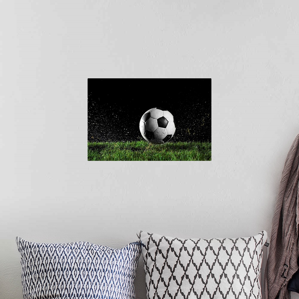 A bohemian room featuring Photographic print of a soccer ball moving across wet grass from a kick.