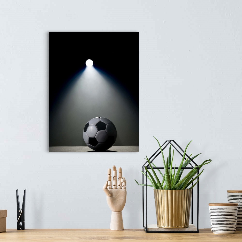 A bohemian room featuring Soccer ball in spotlight