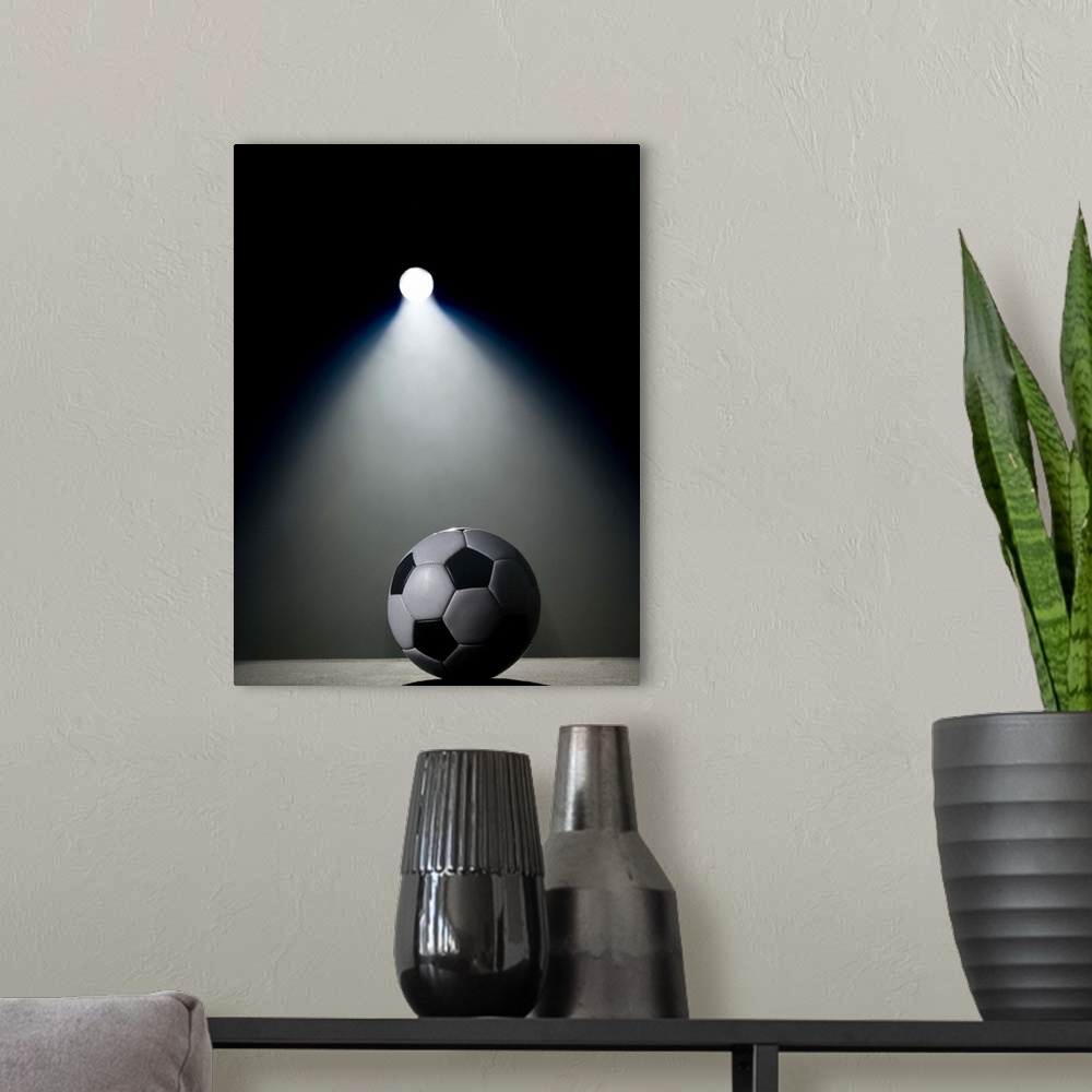 A modern room featuring Soccer ball in spotlight