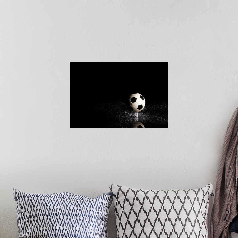 A bohemian room featuring Soccer ball on black reflective surface