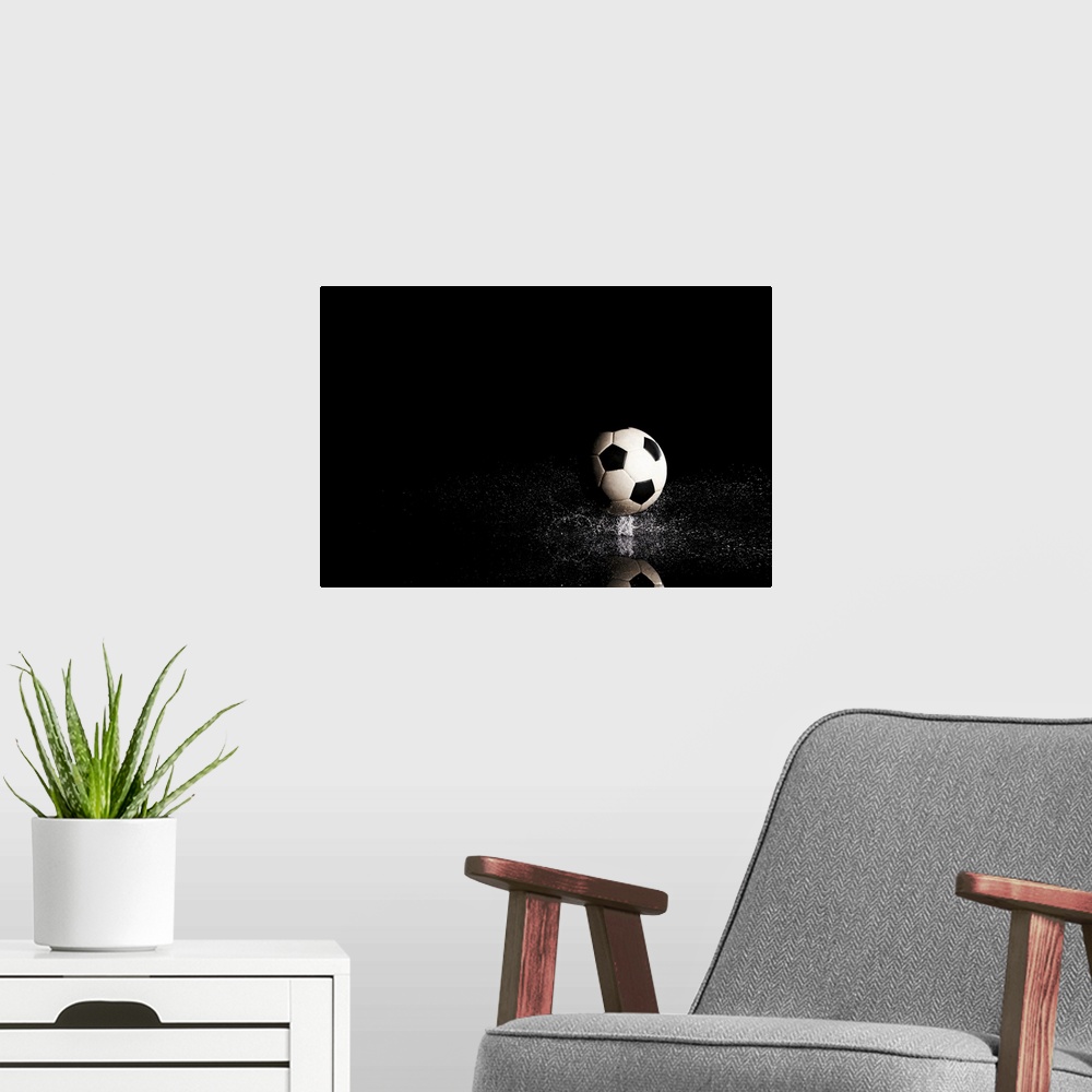 A modern room featuring Soccer ball on black reflective surface