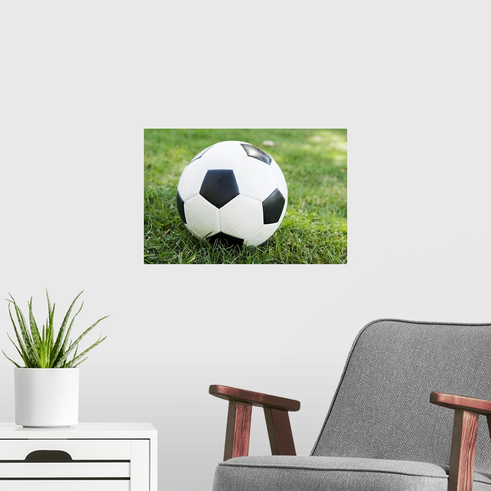 A modern room featuring Soccer ball on grass