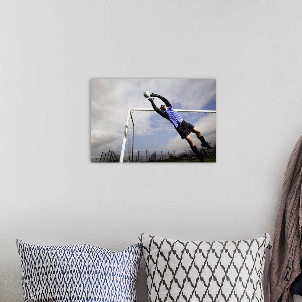 A bohemian room featuring Soccer goalie jumping