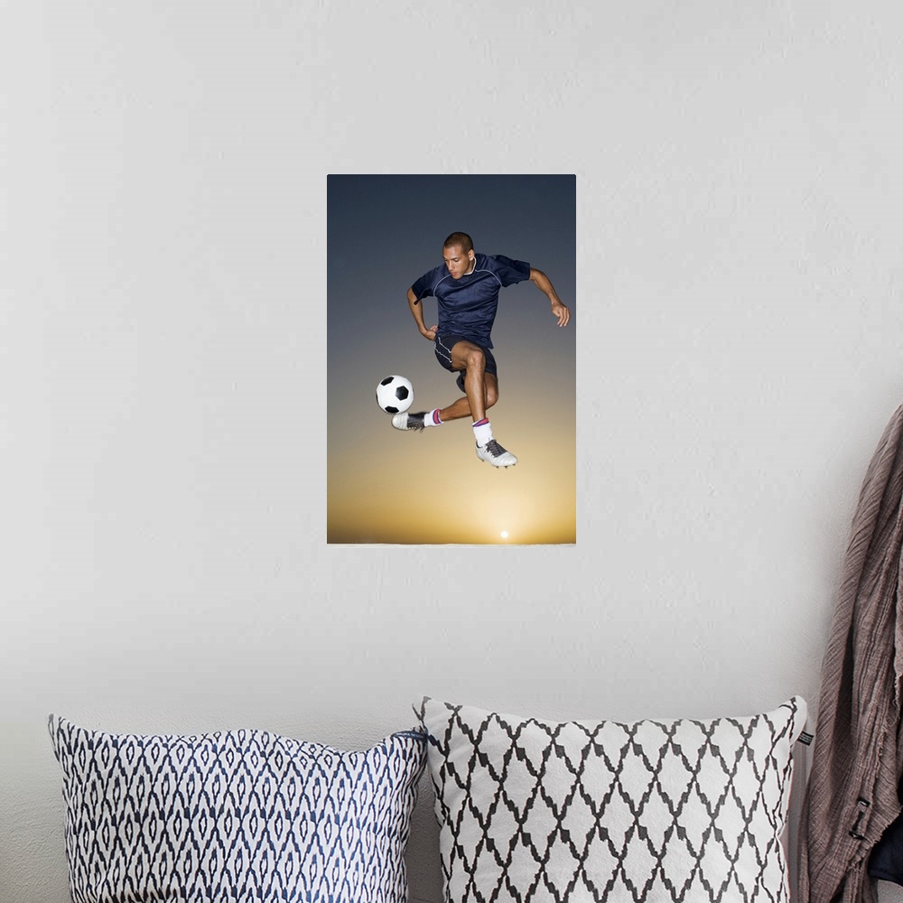 A bohemian room featuring Soccer player kicking ball in mid-air