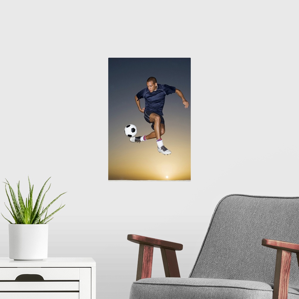 A modern room featuring Soccer player kicking ball in mid-air