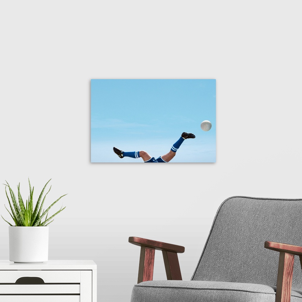 A modern room featuring Soccer Player Upside-Down Attempting To Kick The Ball