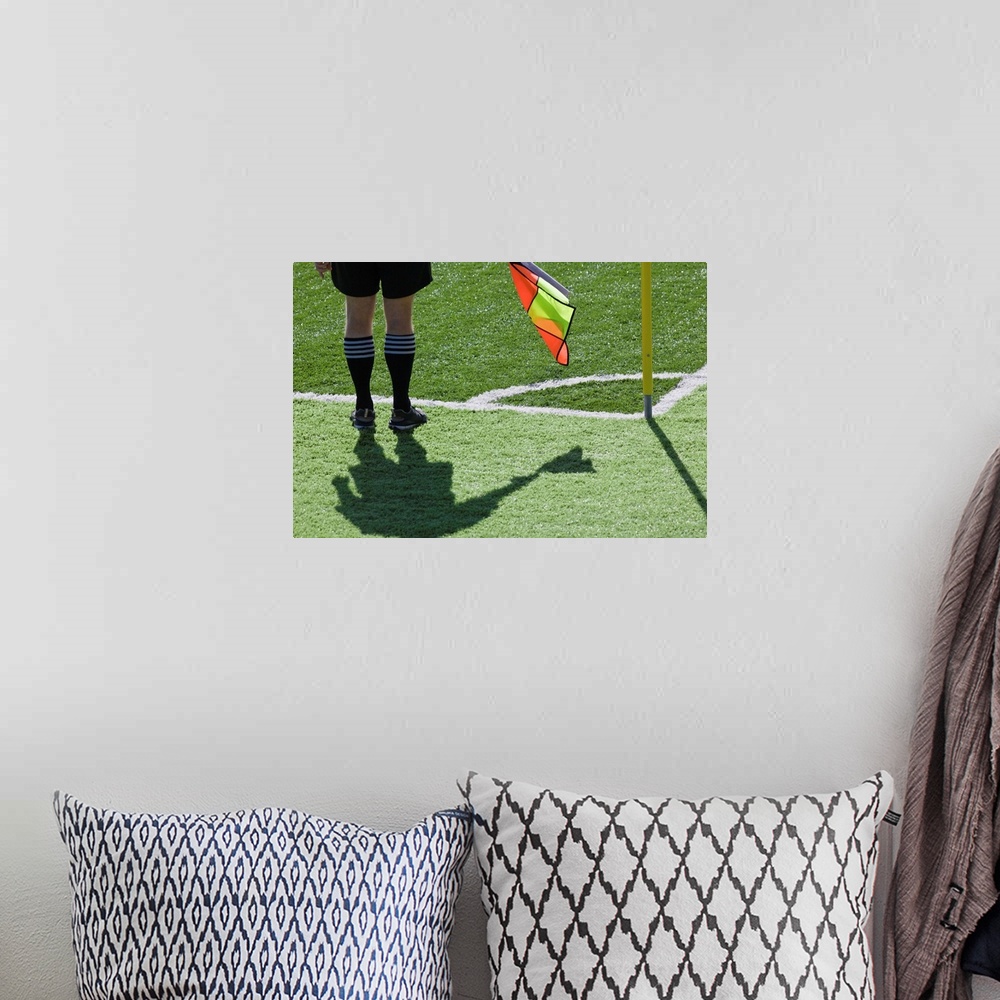 A bohemian room featuring Soccer referee holding flag