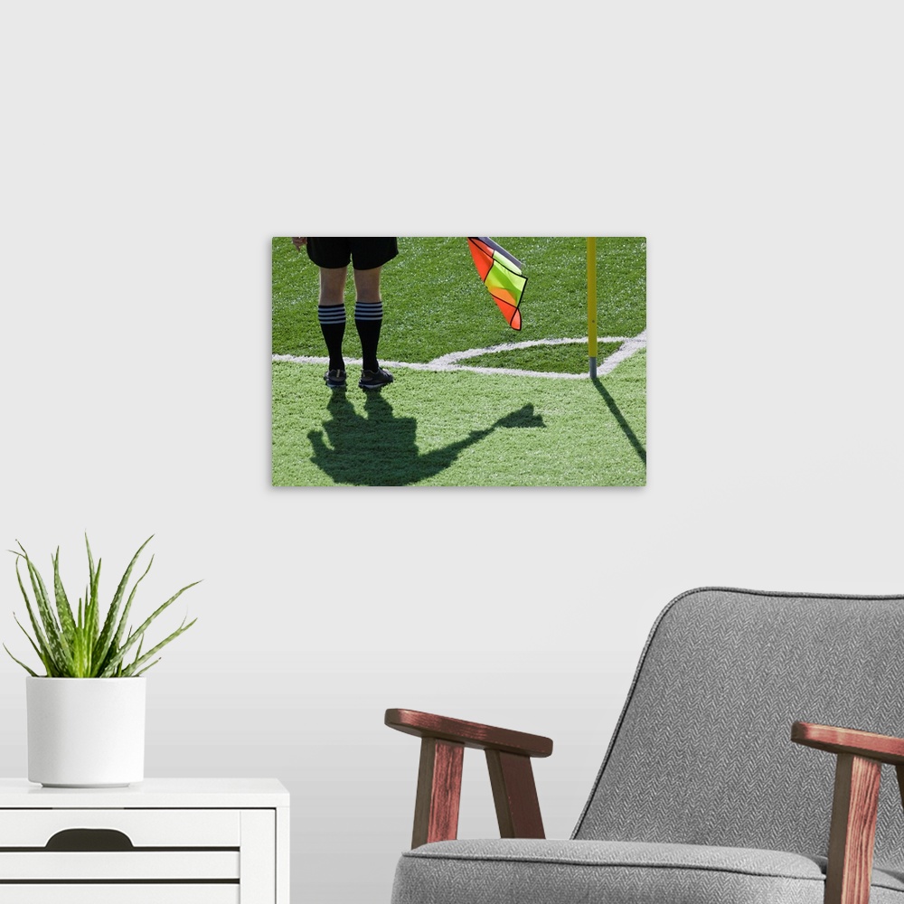 A modern room featuring Soccer referee holding flag