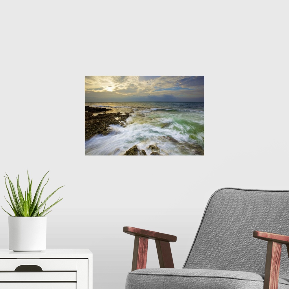 A modern room featuring Rushing waves on coral reefs in Howan, Pingtung, after shower with setting sun shiny behind clouds.