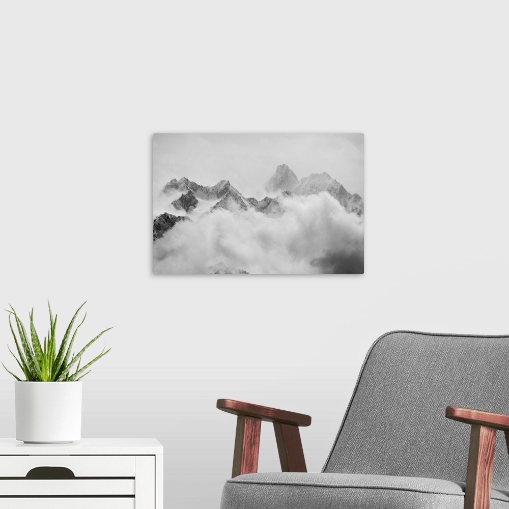 A modern room featuring Atmospheric clouds linger around the peaks of the Swiss alps after a spring snow storm.