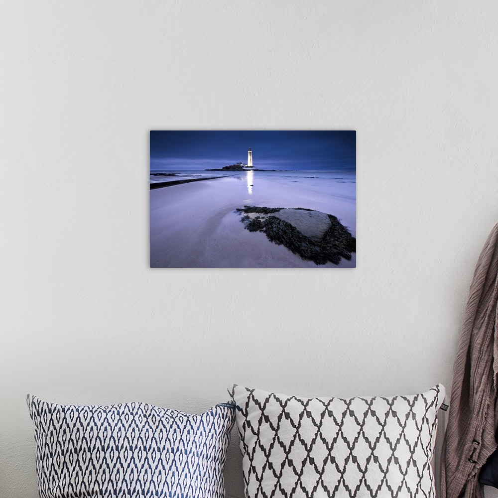 A bohemian room featuring St.Marys Lighthouse, Whitley Bay, glowing at night in blue hour, reflected on sand in front of se...