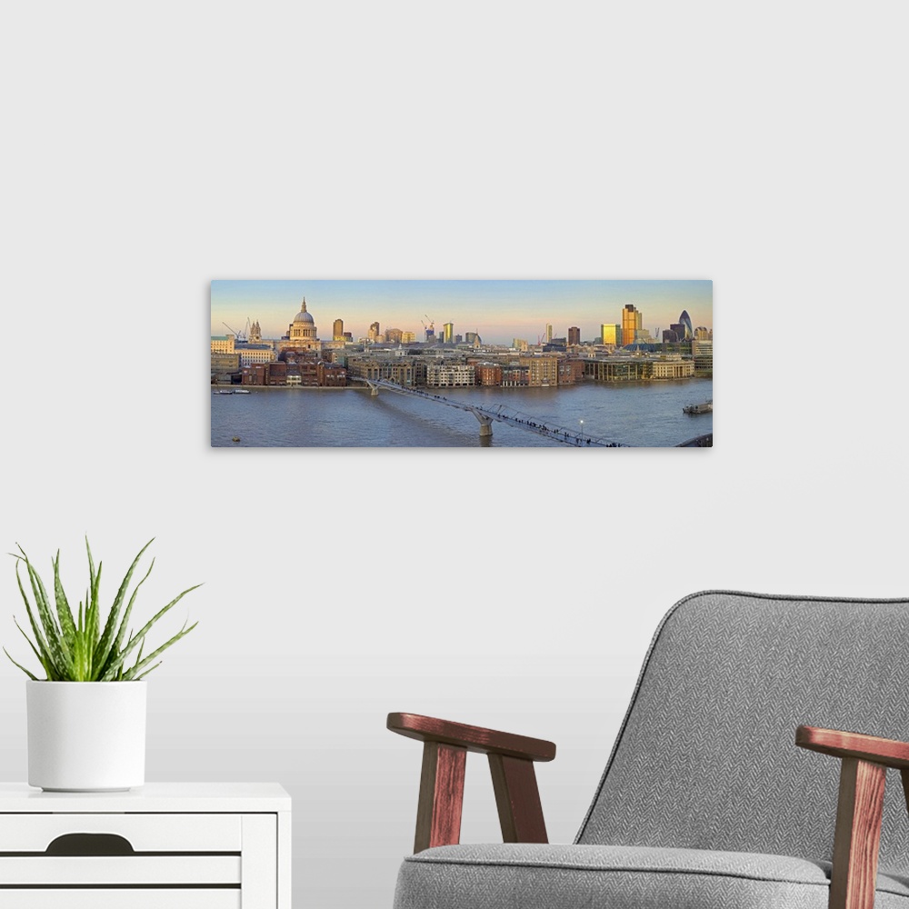A modern room featuring St Pauls Cathedral and City Skyline viewed over the Millennium Bridge at Dusk