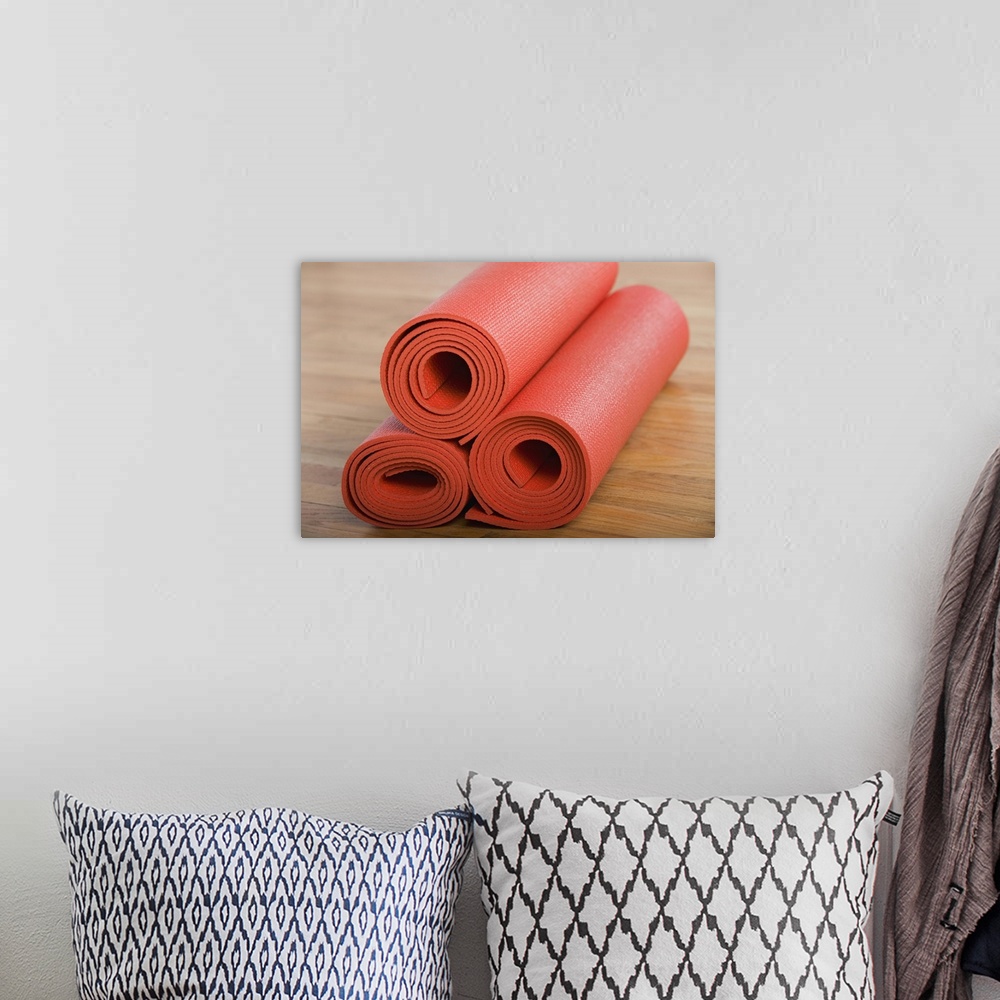 A bohemian room featuring Stack of rolled yoga mats