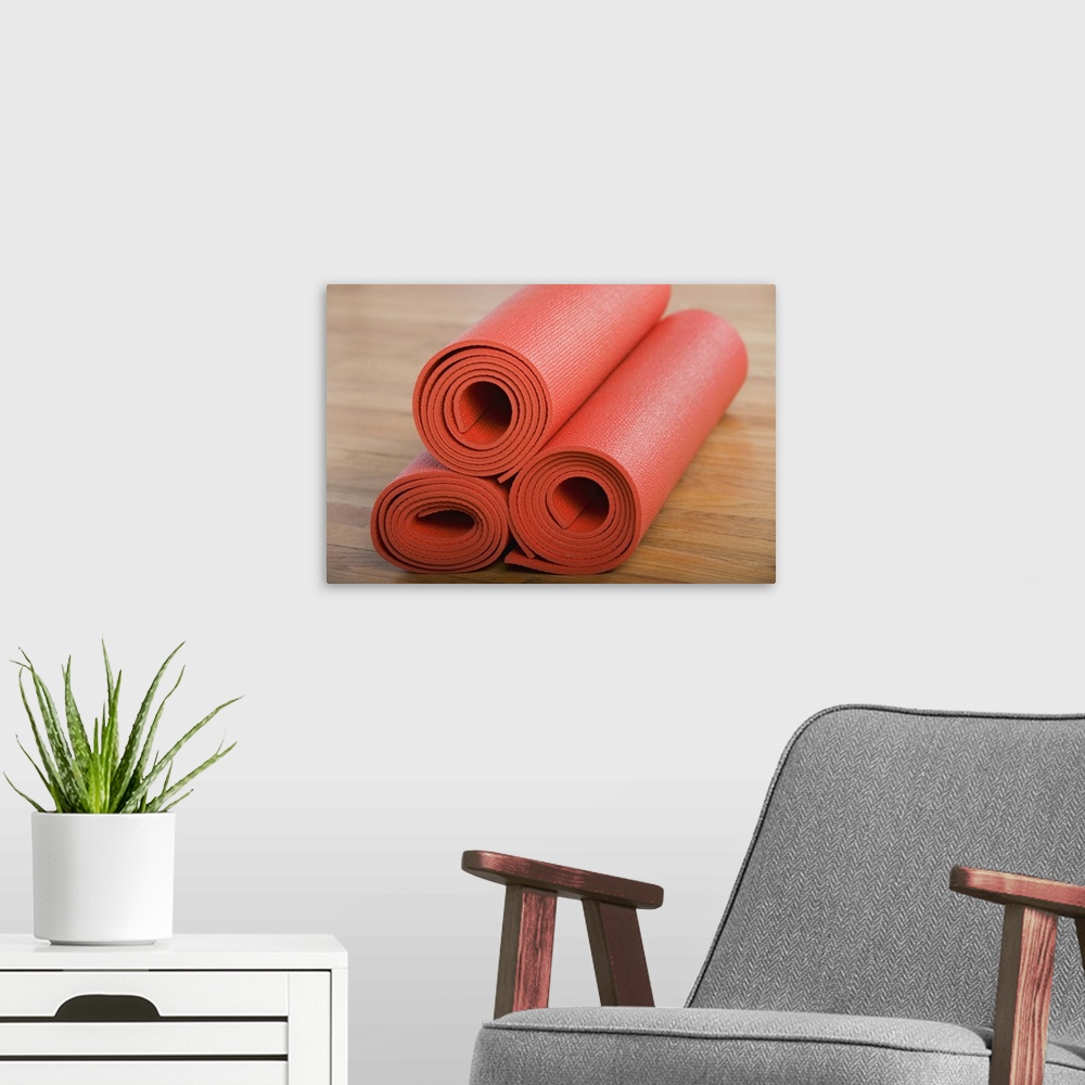 A modern room featuring Stack of rolled yoga mats