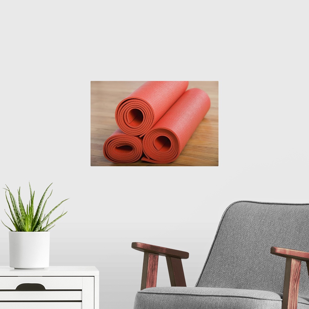 A modern room featuring Stack of rolled yoga mats
