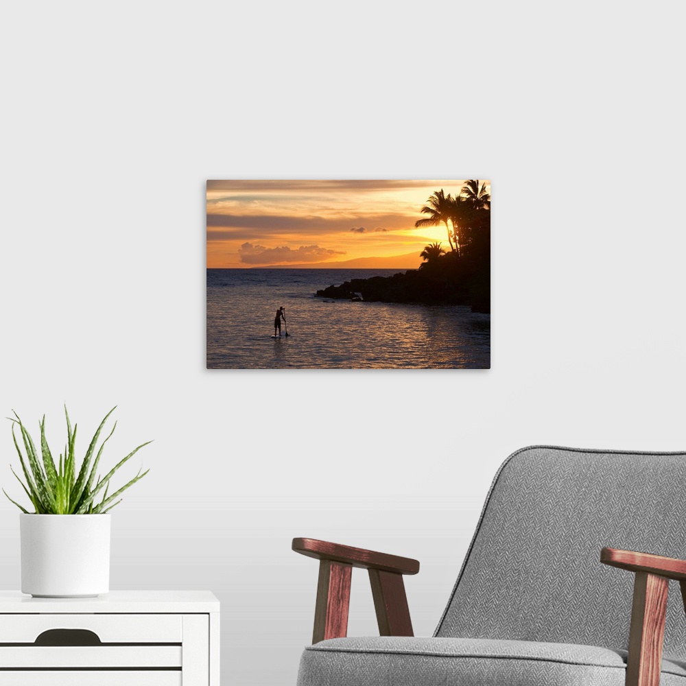 A modern room featuring Man stand-up paddling at sunset in south Maui at Makena, Maui, Hawaii MR